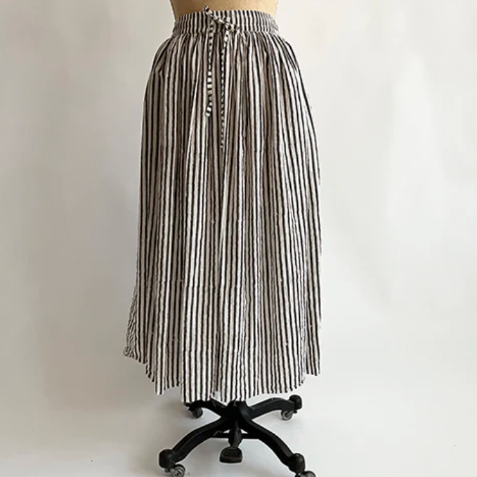 Black and white striped skirt on a mannequin against a plain background