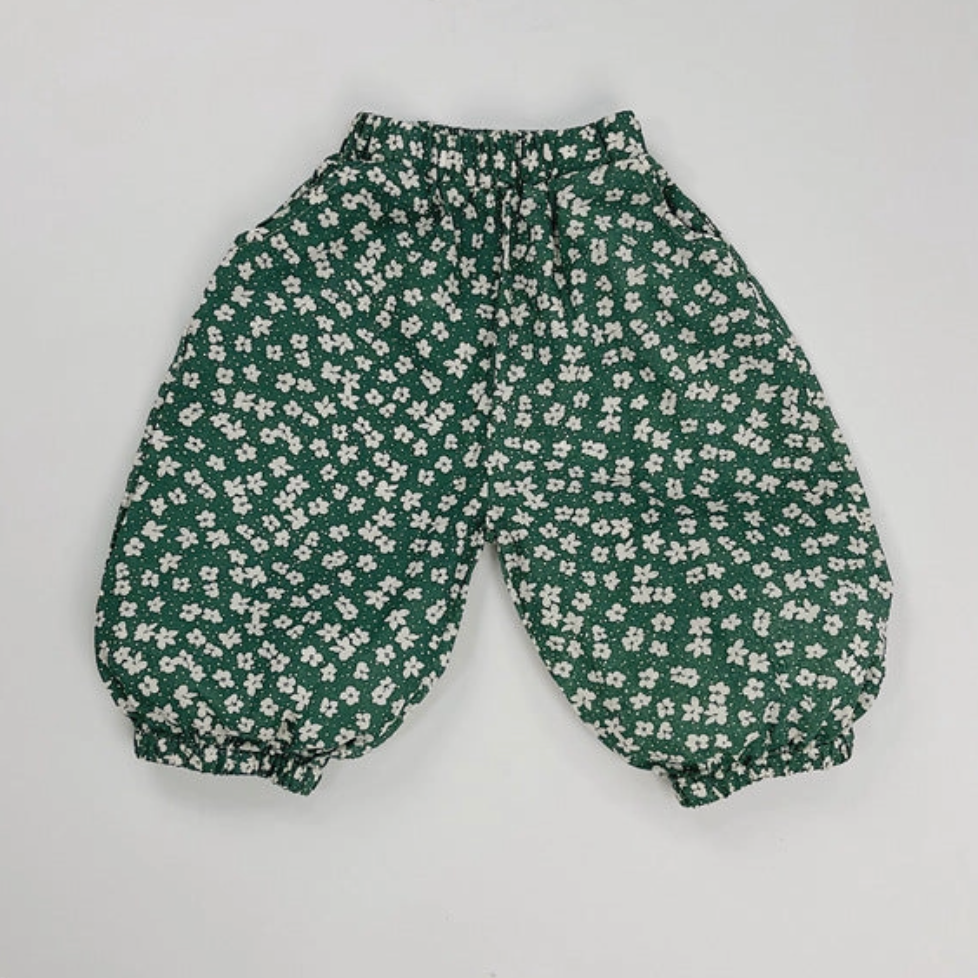 Green floral-patterned pants on a light gray background