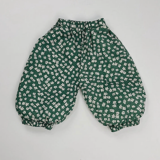 Green floral-patterned pants on a light gray background