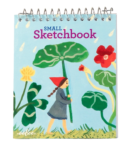 A small spiral-bound sketchbook with a whimsical illustration on the cover. The cover features a light blue background with the text 'SMALL Sketchbook' in purple and blue, and an illustration of a girl in a red hat and gray dress drawing with a green nasturtium plant.