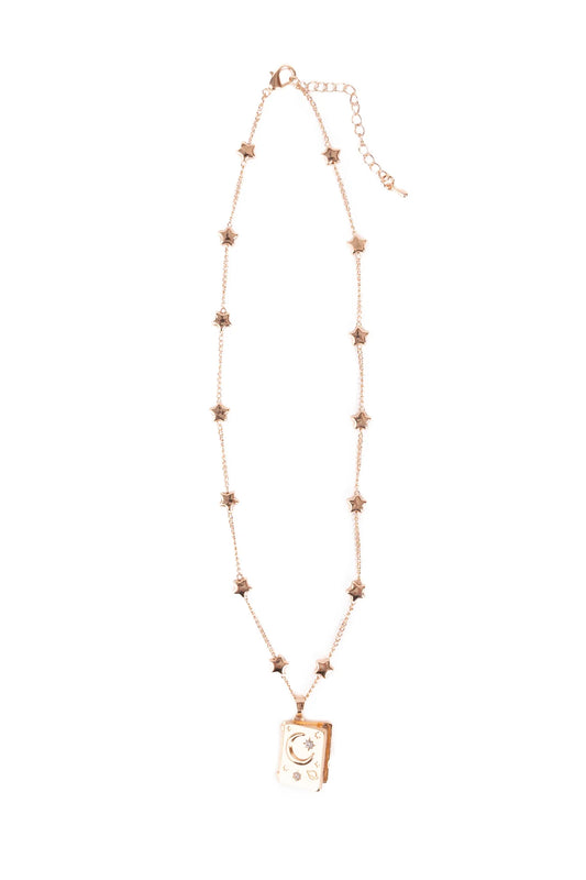 Great Pretenders It Must Be in the Stars Locket, full-length view of a rose gold star charm chain necklace with a book-shaped locket pendant engraved with a crescent moon and stars, on a white background
