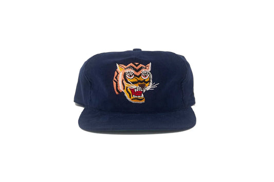 Front view of the Tiger III Navy Snapback in Corduroy featuring a colorful embroidered roaring tiger patch on a navy 21-wale corduroy upper.