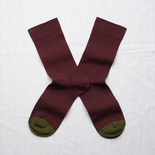 Bonne Maison Solid Burgundy Socks, flat lay pair showing solid burgundy body with contrast olive heel and toe
