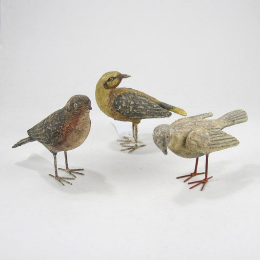 Three bird figurines on a white background