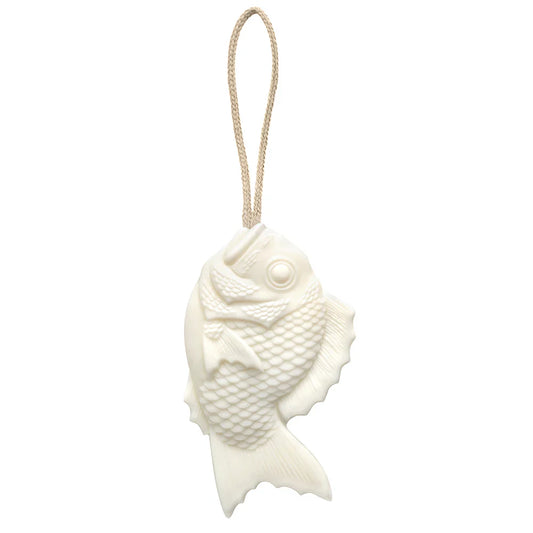 Tamanohada Lily Welcome Soap in the shape of a Japanese bream fish, white plant-based soap with detailed scale texture, hanging from a natural braided linen rope — product view on white background
