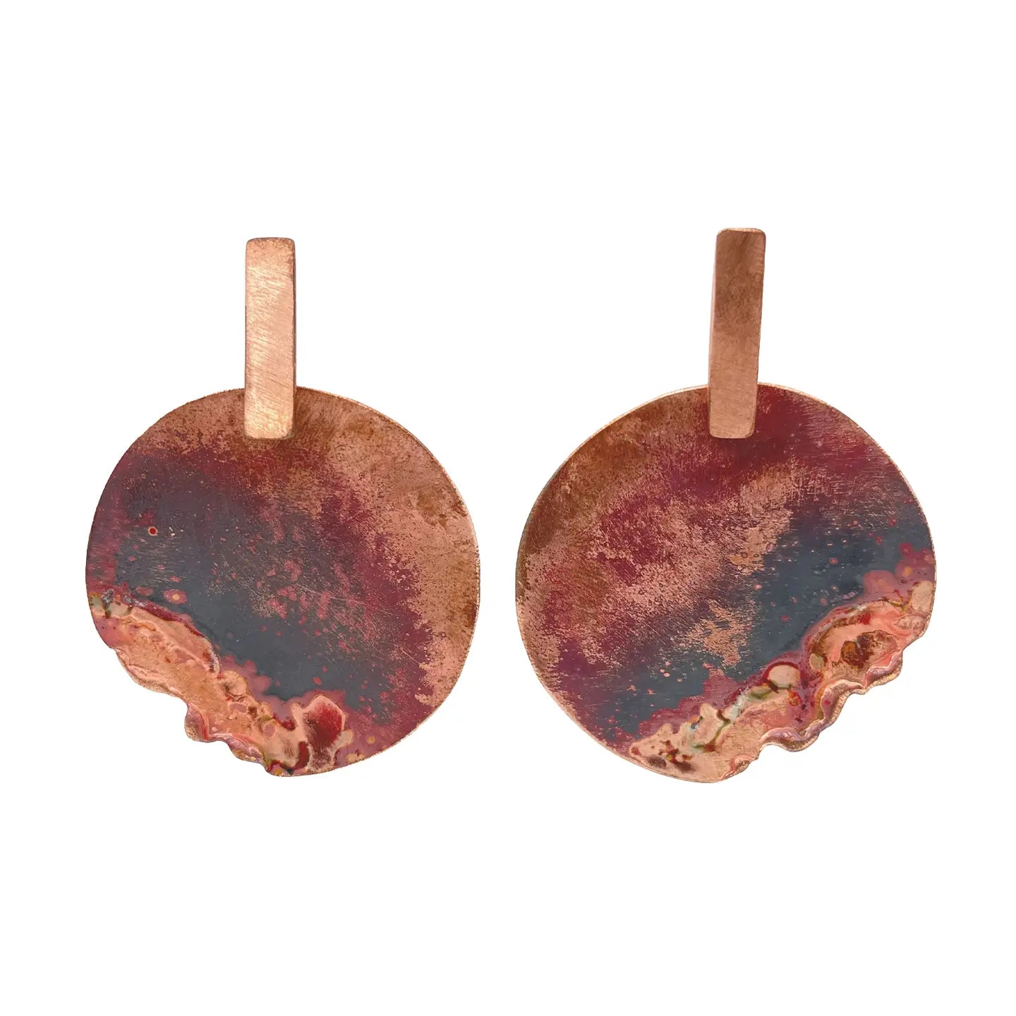 Pair of Sibilia Marea Metalic Earrings in Canyon, featuring large round treated brass disc drops with a raw canyon red, burgundy, and copper oxide patina finish, on copper rectangular bar posts, on a white background
