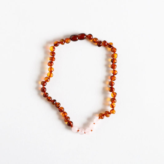 Necklace with amber beads on a white background