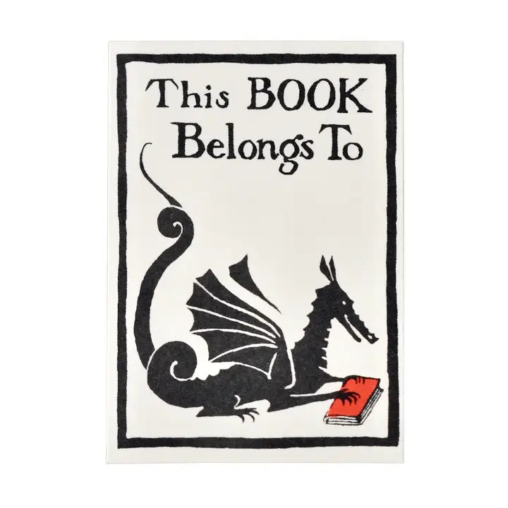 A square decorative sign or print with the text 'This BOOK Belongs To' above a black dragon illustration reading a red book, on a white background with a thin black border.