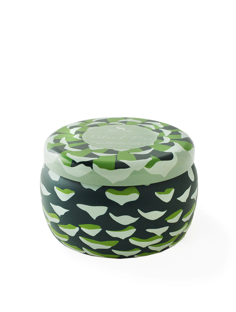 Roland Pine soy candle tin with its lid closed, showing a green, cream, and dark patterned design on white.
