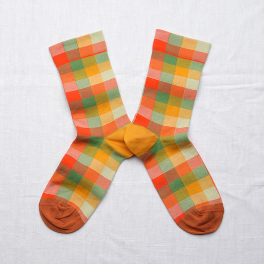 Bonne Maison Multicolor Plaid Socks, flat lay pair showing the multicolor plaid pattern in orange, red, green, yellow, and cream with mustard heel and toe
