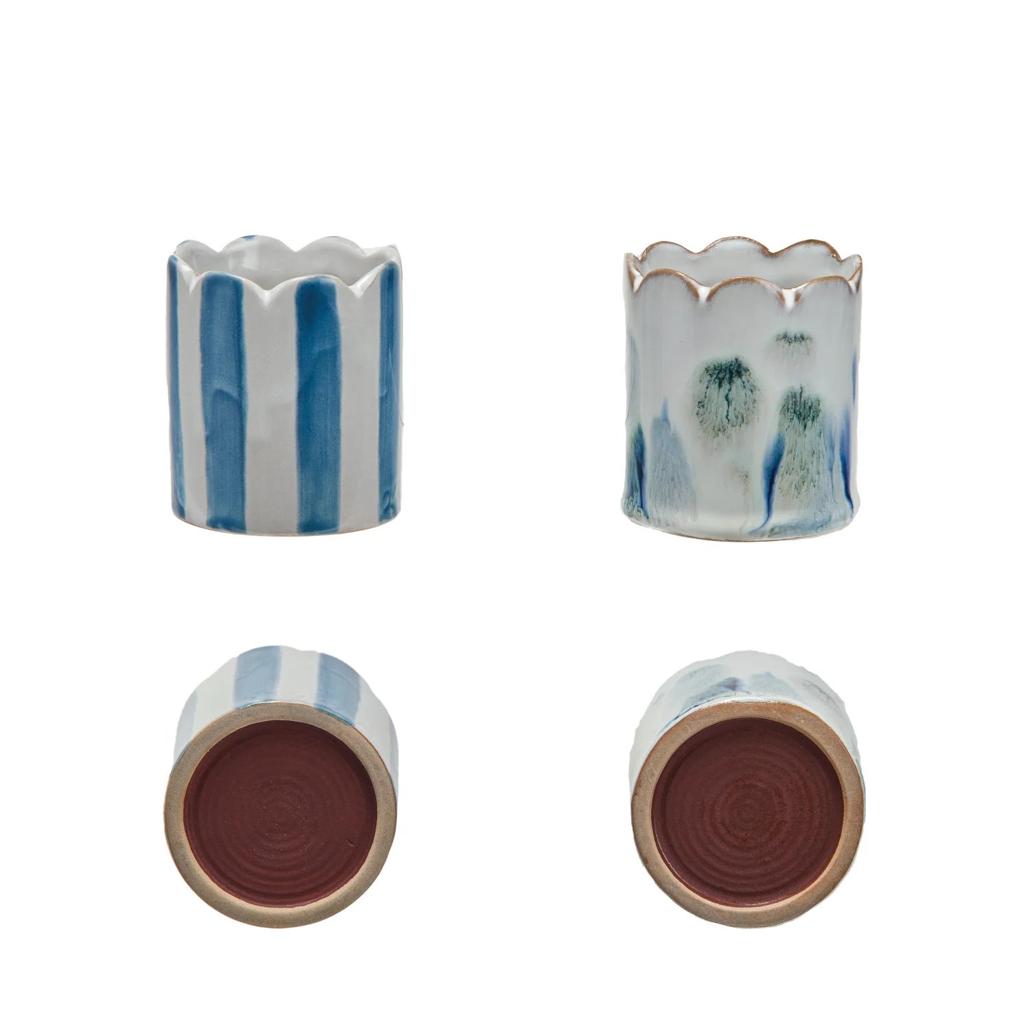 Set of four ceramic pots with striped and textured designs on a white background