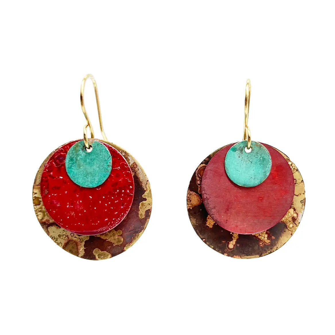 Pair of Sibilia Planets Earrings in Mixed Canyon Patina, featuring three stacked round treated brass discs — a large gold and brown patina base, a red oxide mid disc, and a small turquoise patina top disc — hanging from gold wire hooks, on a white background