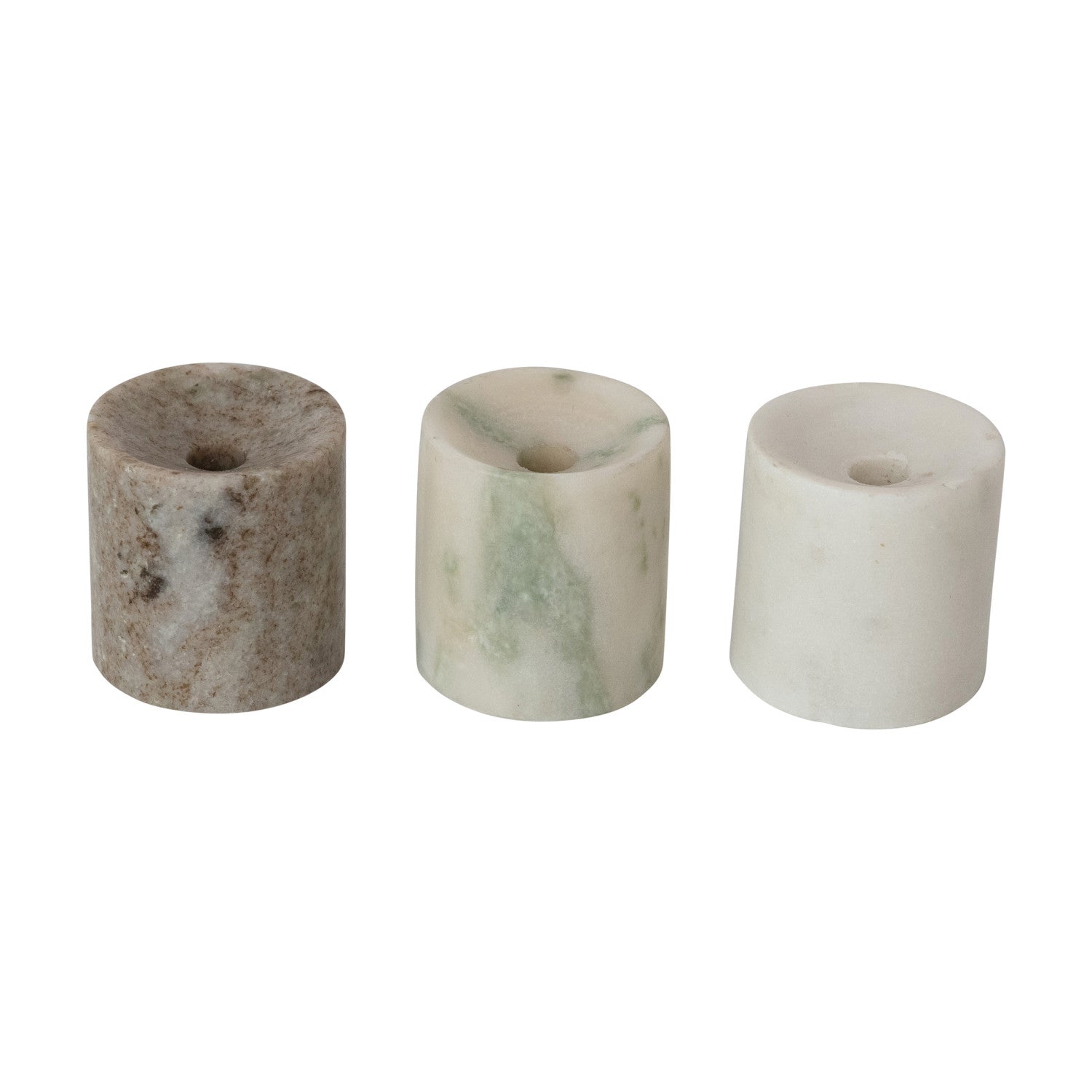 Three cylindrical marble candle holders on a white background