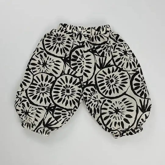Black and white patterned pants on a light gray background.
