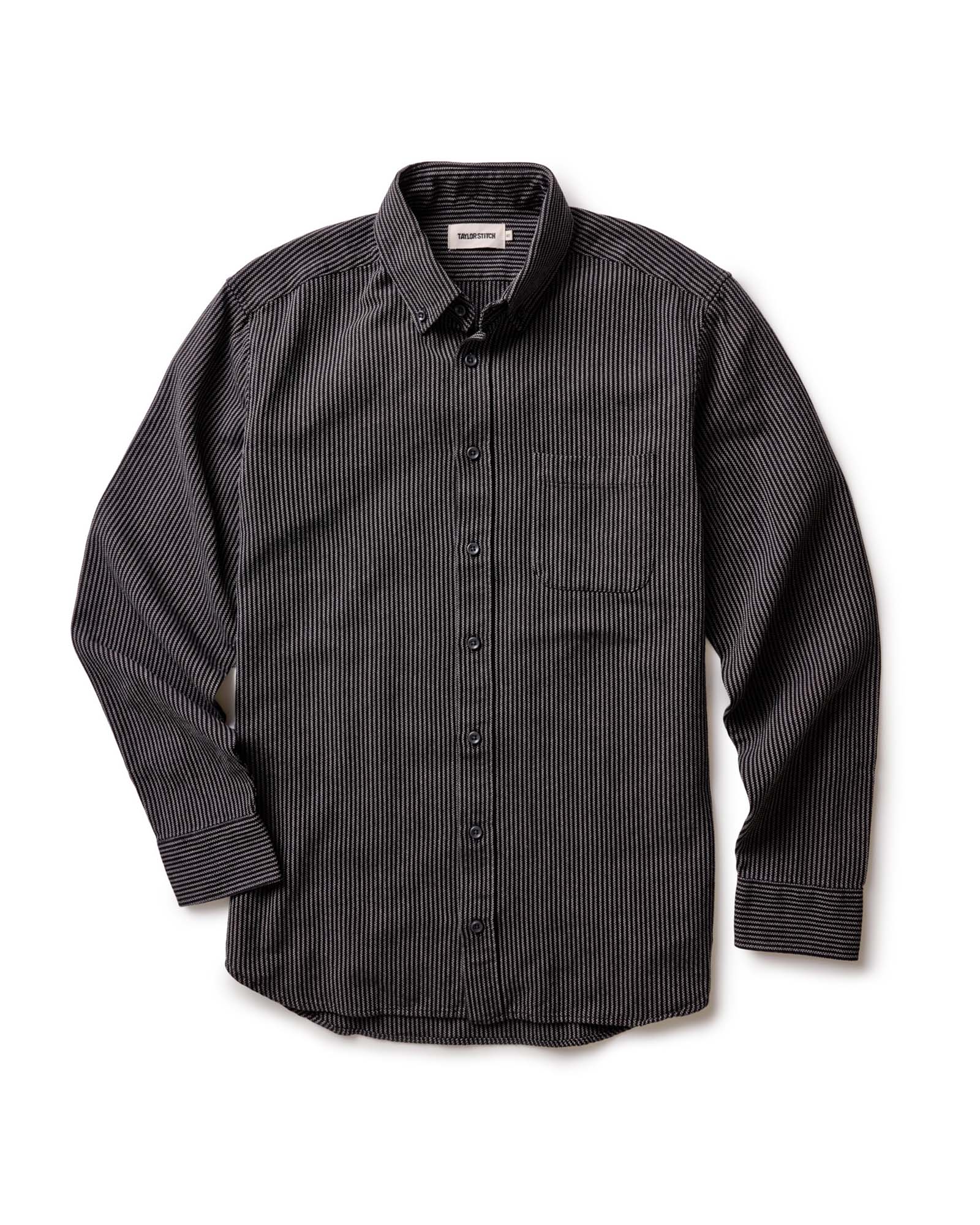 The Jack in Roped Black Indigo by Taylor Stitch, flat lay front view showing full shirt silhouette, button-down collar, chest pocket, and long sleeves