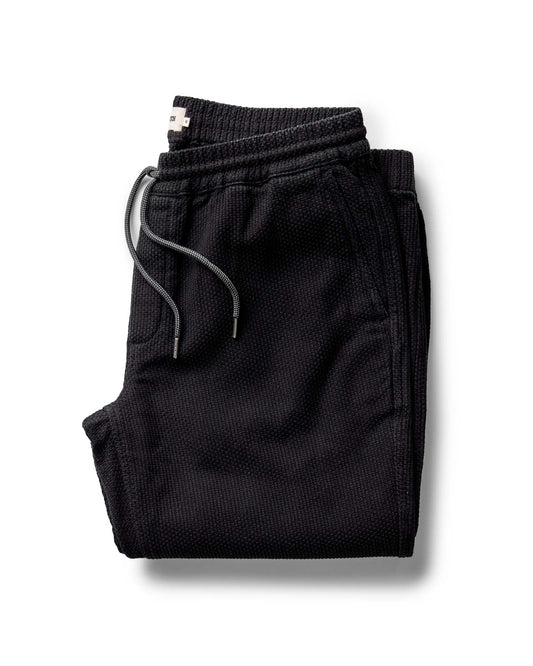 Folded black pants on a white background