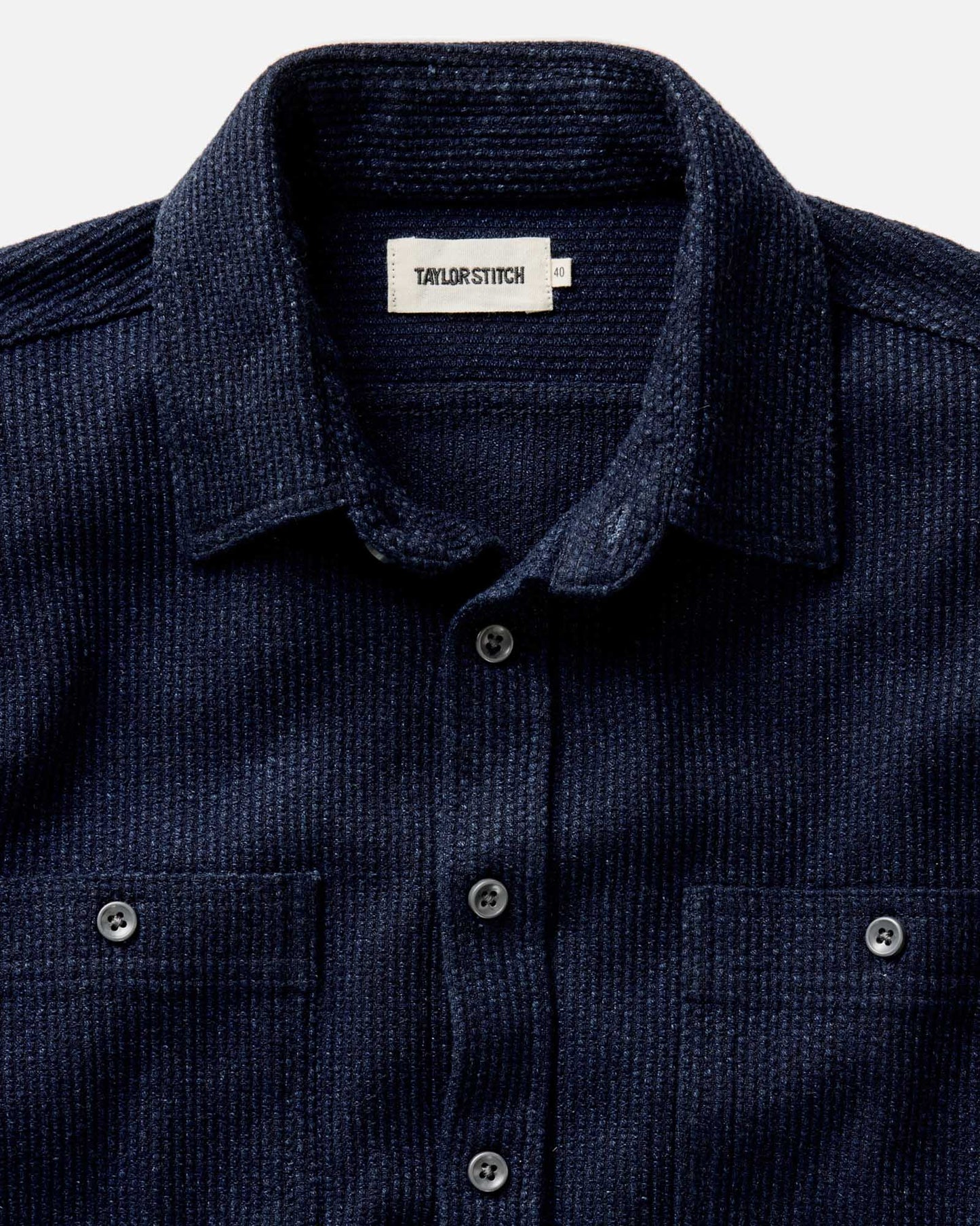Model wearing Taylor Stitch Utility Shirt in Rinsed Indigo Sashiko, back view showing deep rinsed indigo sashiko weave, two back pleats for ease of movement, and double-needle felled seam construction
