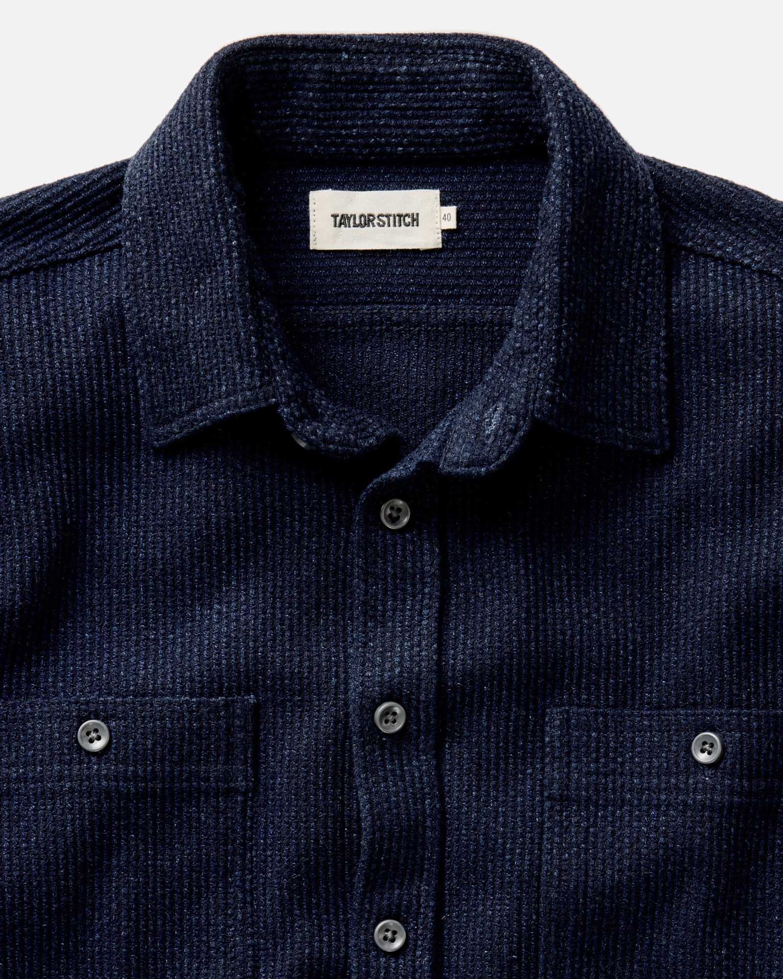 Model wearing Taylor Stitch Utility Shirt in Rinsed Indigo Sashiko, back view showing deep rinsed indigo sashiko weave, two back pleats for ease of movement, and double-needle felled seam construction

