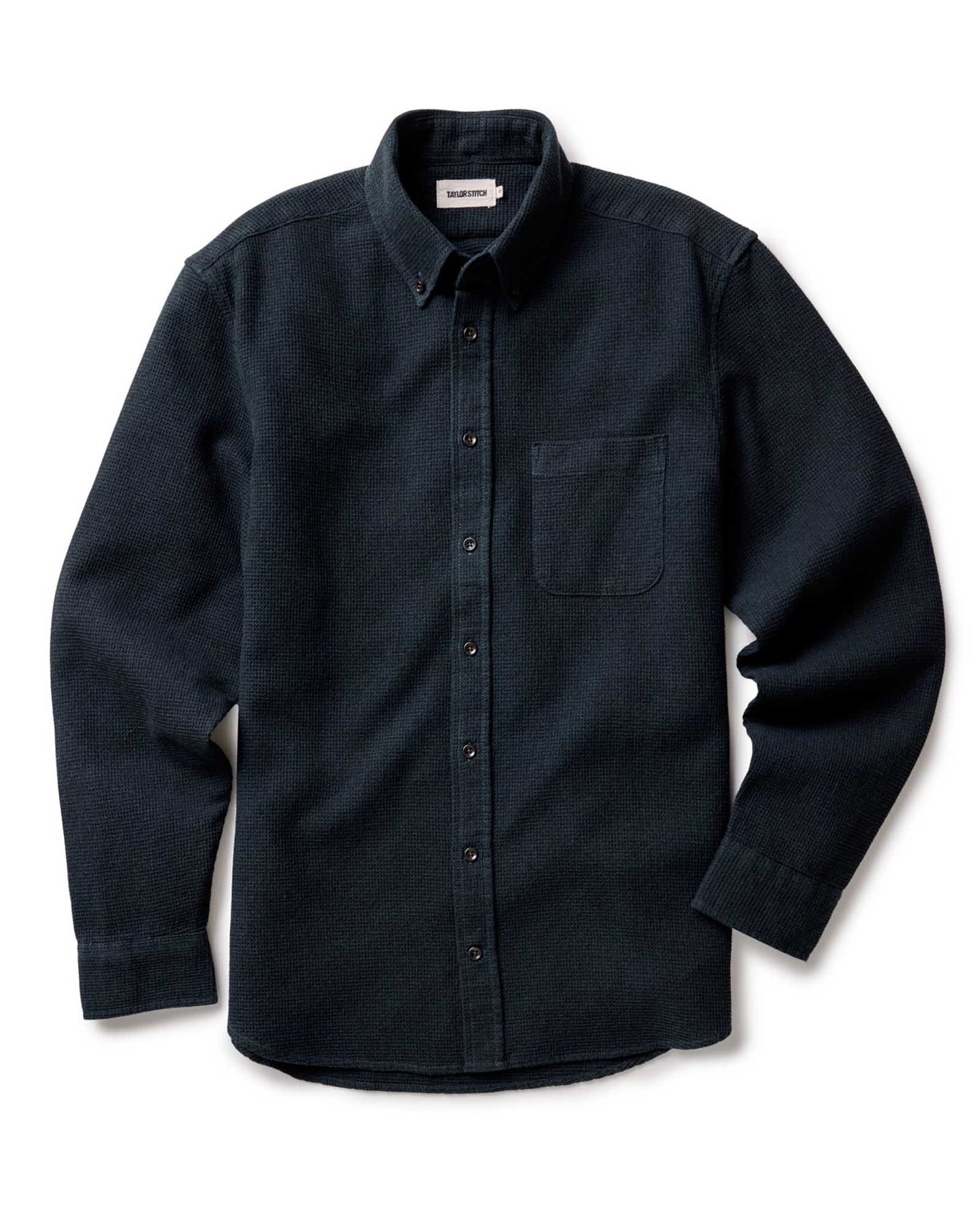 Taylor Stitch Jack Shirt in Forest Waffle, flat lay front view showing dark forest green waffle-knit fabric, button-down collar, chest pocket, and lock-stitched buttons on white background