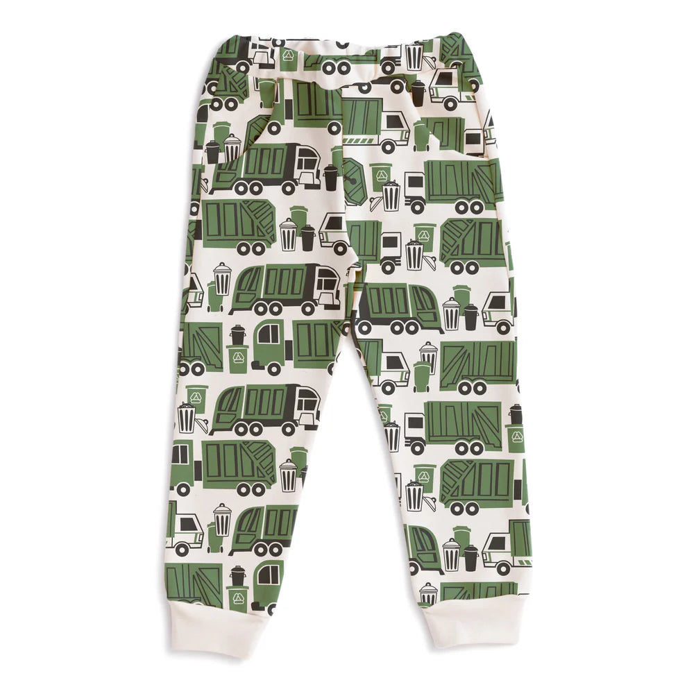 A pair of children's jogger pants with an all-over green garbage truck pattern on a cream background, featuring ribbed cuffs at the ankles.