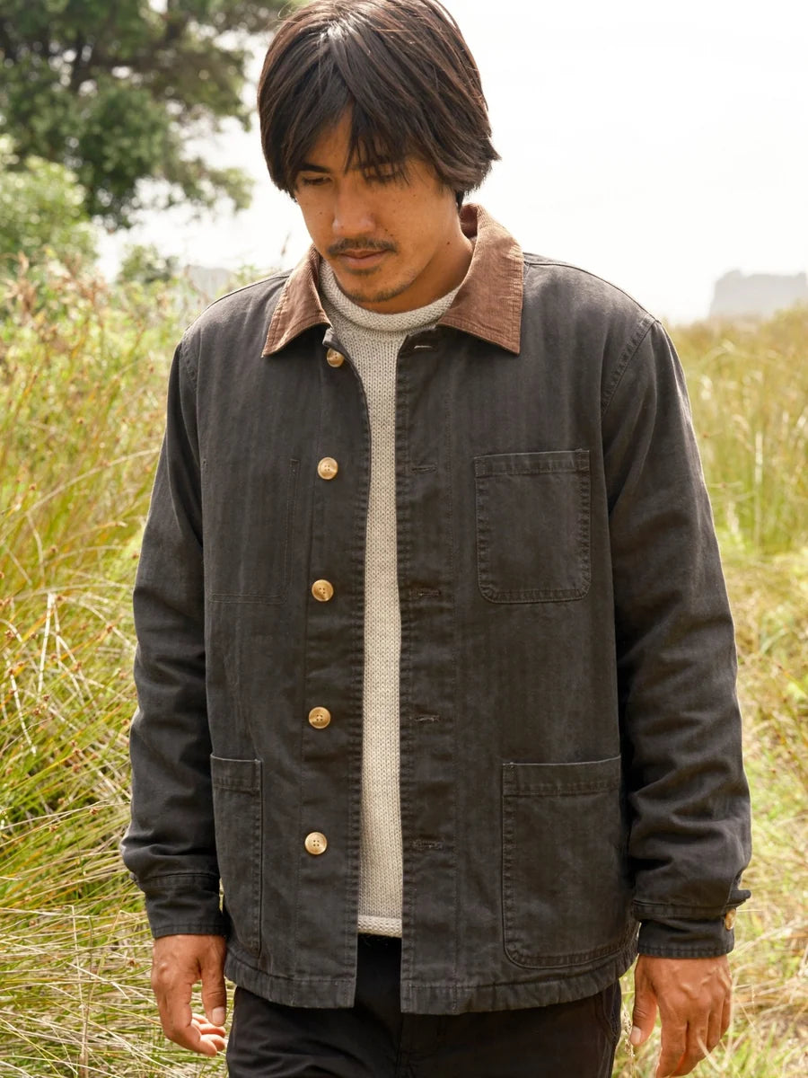 Front view of a model wearing the navy Lined Builder Jacket with a brown corduroy collar and patch pockets.
