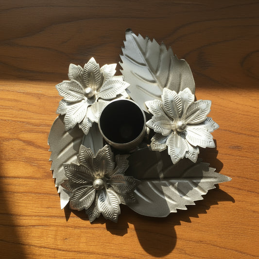 Decorative metal object with floral designs on a white background
