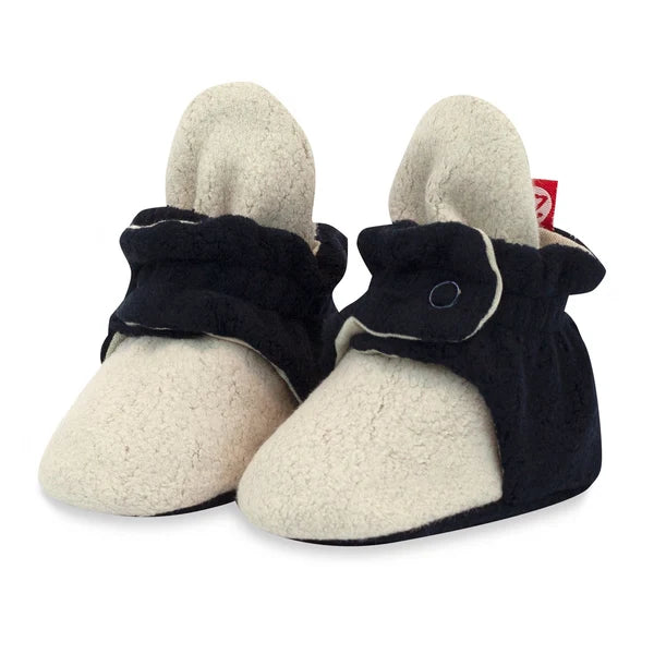 Pair of Zutano Khaki/Black color block fleece baby booties, with khaki toes and black wraparound snap straps.
