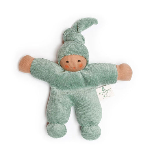 An organic terry baby doll in sage green with a cap, made by Nanchen.