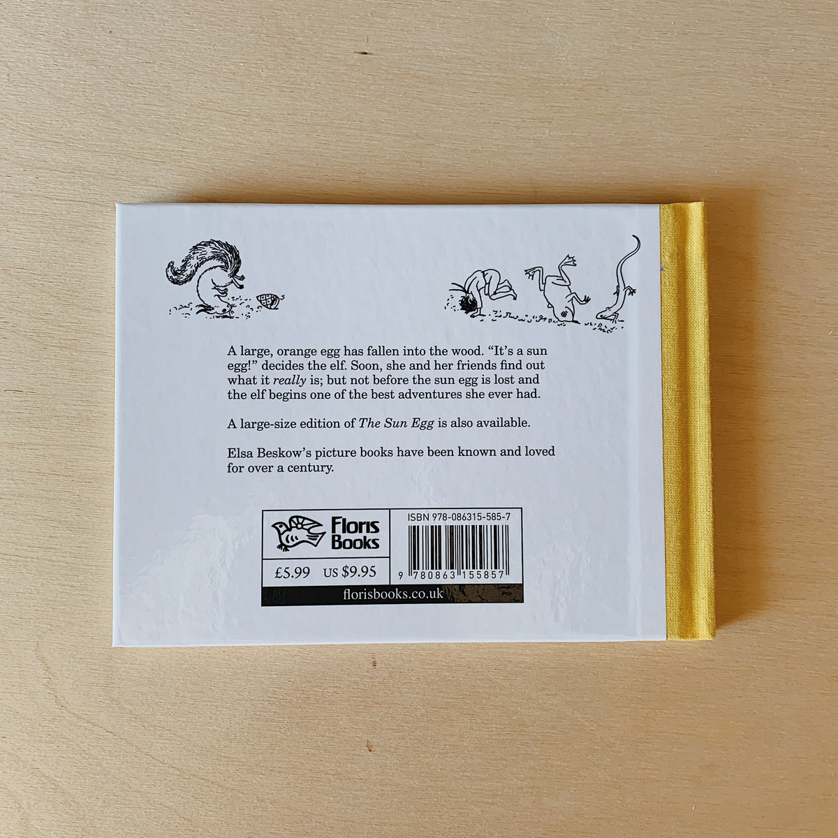 Back cover of The Sun Egg, mini edition, with small woodland illustrations above the story summary and a yellow spine.
