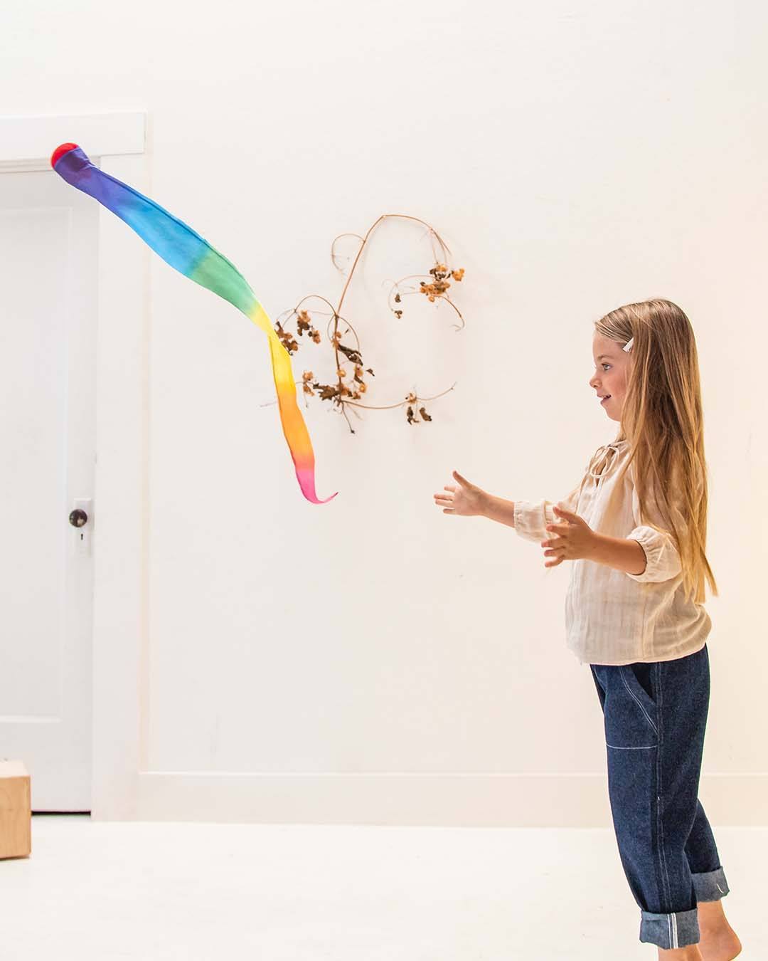 Child throwing the skytail away from herself.