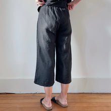 Load image into Gallery viewer, Back view of model&#39;s legs wearing black linen pants and black Birkenstock sandals
