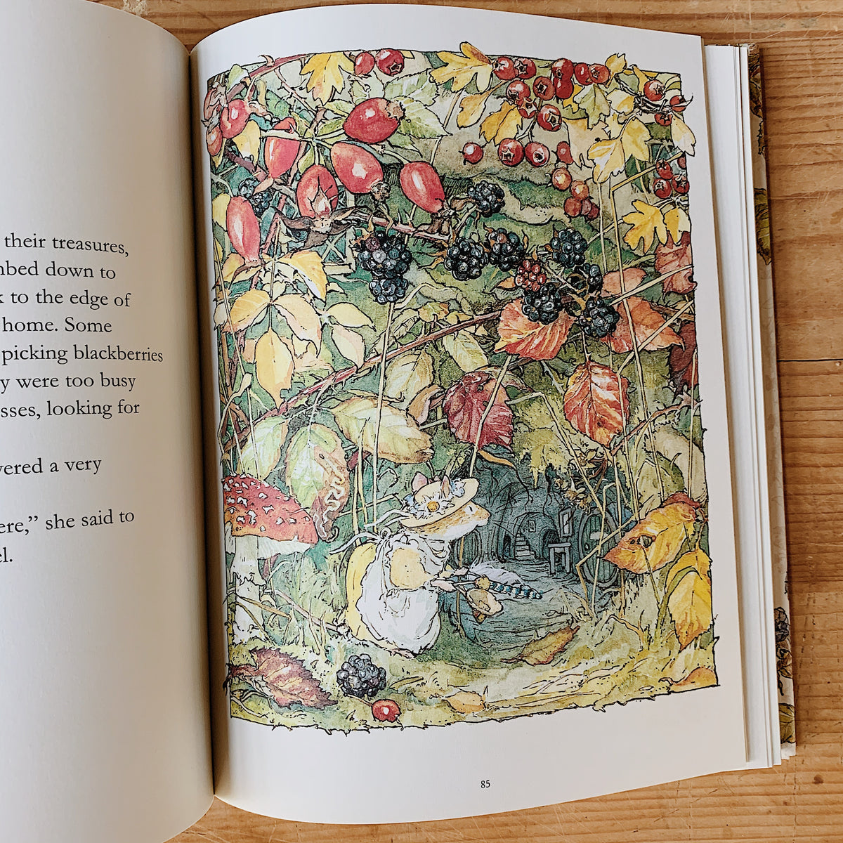Interior illustration from The Complete Brambly Hedge showing a mouse carrying a basket beneath blackberry vines and autumn leaves.

