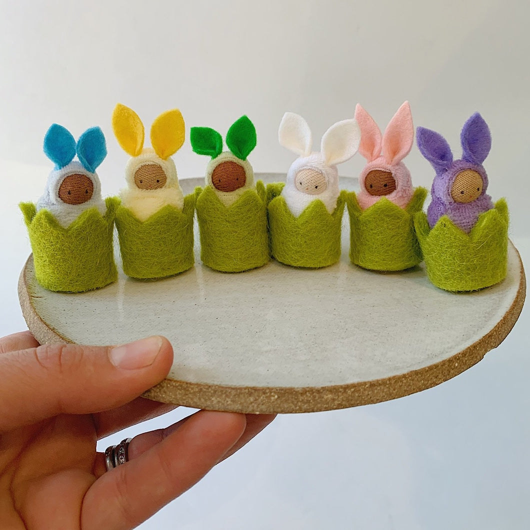 felt baby bunnies lined up on little tray front view