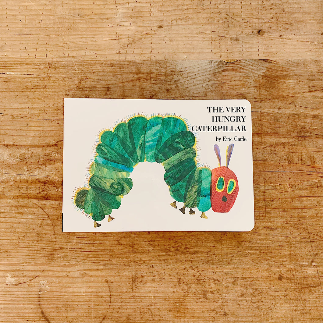 the very hungry caterpillar front cover on wooden background