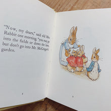 Load image into Gallery viewer, tale of peter rabbit laydown inside pages shot top view on wooden background
