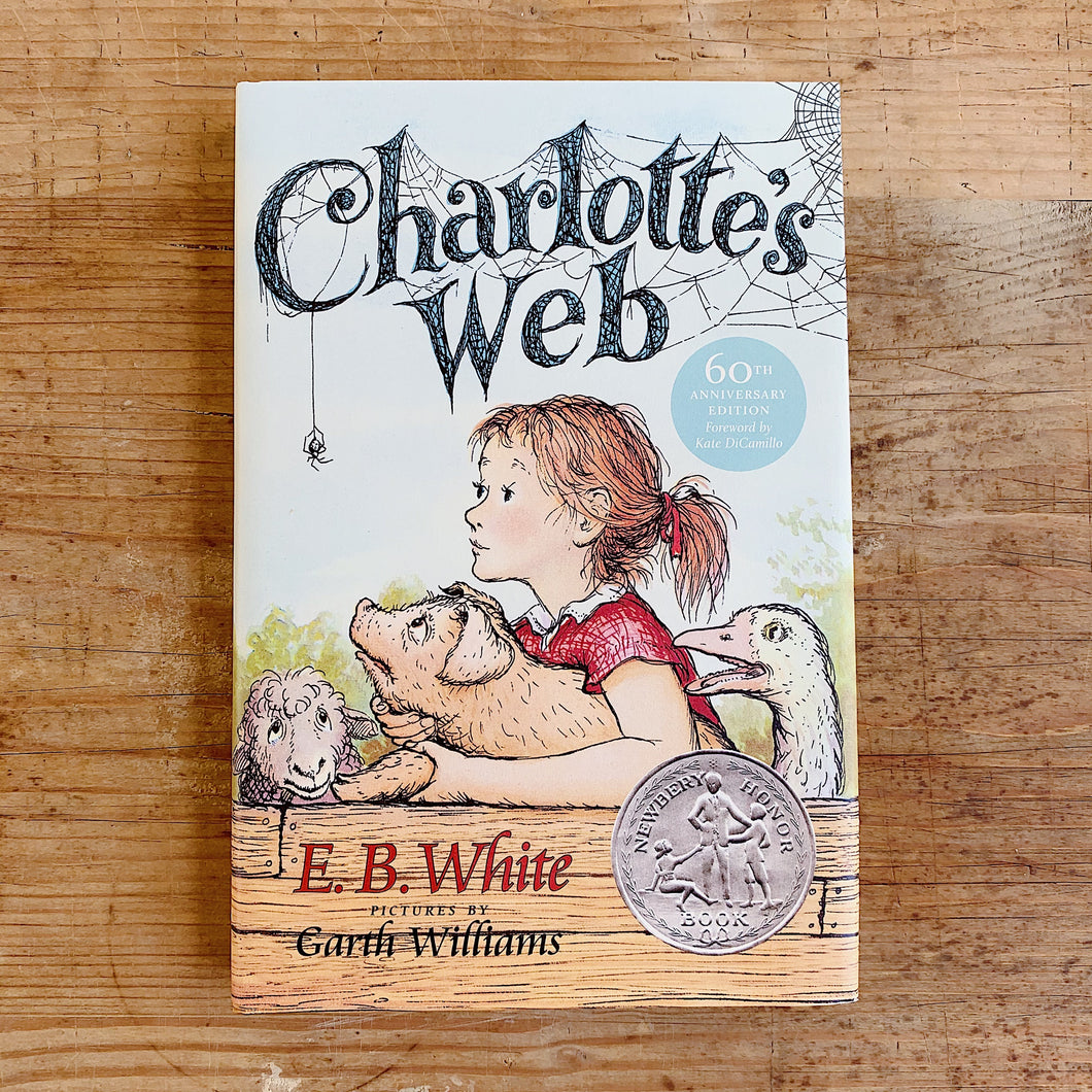 charlotte's web laydown cover on wooden background