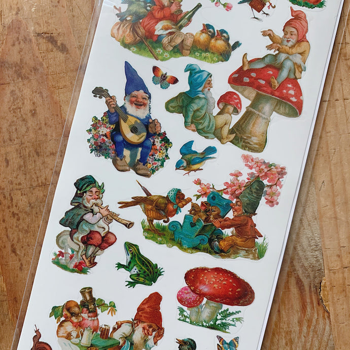 Overhead close up shot of garden gnomes and forest mushroom stickers