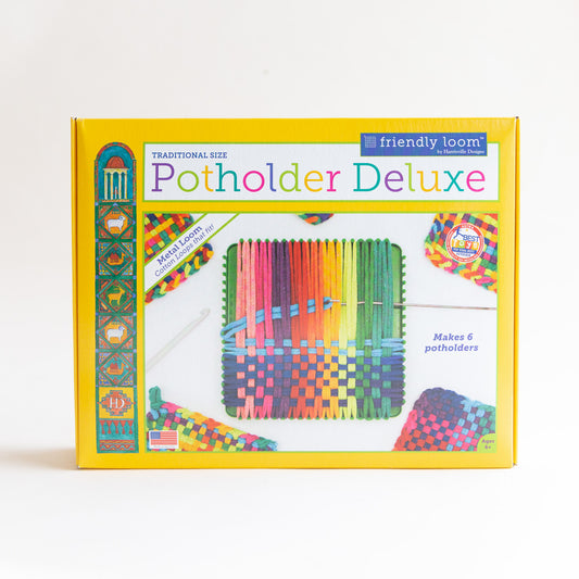 Front of the Harrisville Designs Friendly Loom Potholder Deluxe kit box in yellow, showing a metal loom strung with rainbow cotton loops and completed colorful woven potholders
