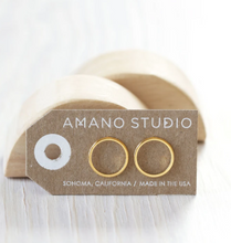 Load image into Gallery viewer, amano studio gold circle stud earrings seen in packaging standing up
