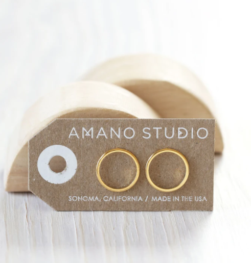 amano studio gold circle stud earrings seen in packaging standing up