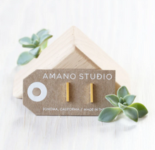 Load image into Gallery viewer, amano studio gold bar stud earrings laid out in packaging
