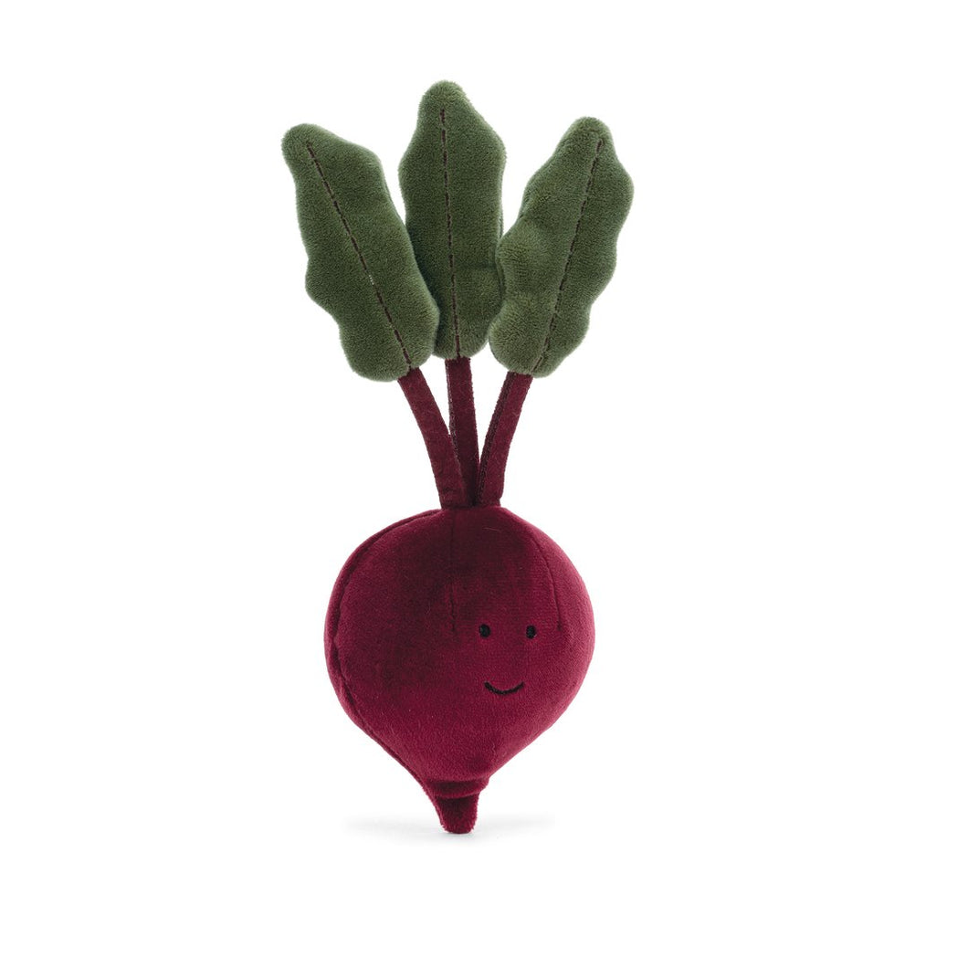 deep purple colored beetroot stuffy featuring a simple smiley face, photographed against a white background