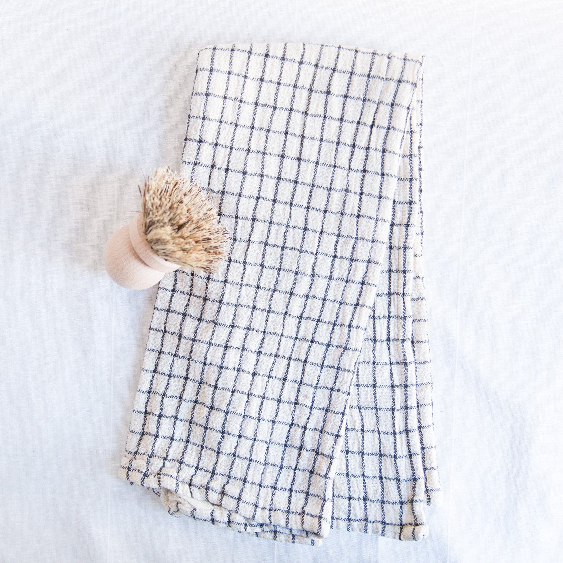 checkered cotton dishtowel with wooden scrub